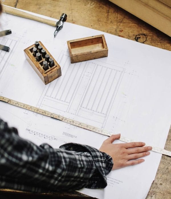 young-craftswoman-measuring-blueprint-in-pipe-orga-2024-11-03-05-31-53-utc.jpg